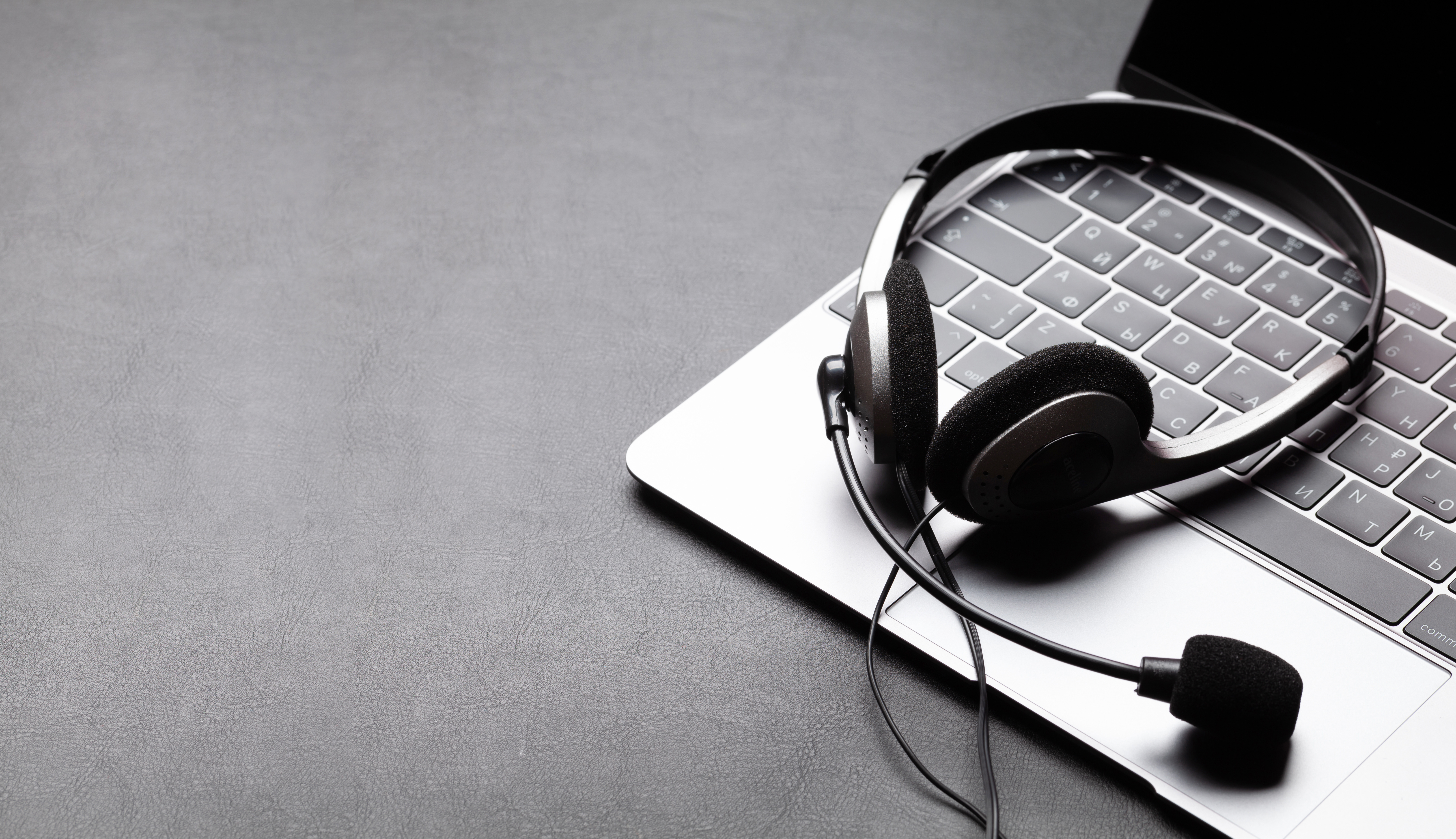 Office desk with headset and laptop